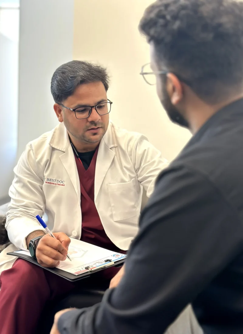 Dr Riyaz consulting a patient at their Home